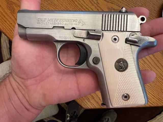 Colt Mustang 380 stainless with ivory grips.